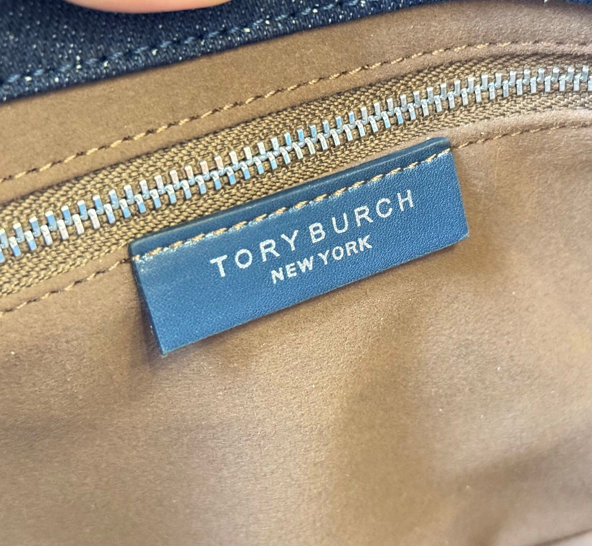 Denim TORY BURCH CHARLE DRNIM SHOULDER BAG denim underarm bag with deep blue denim and contrasting caviar patterned shoulder straps, simple yet textured. The front double T metal logo is highly recognizable, and the underarm back or single shoulder crossb