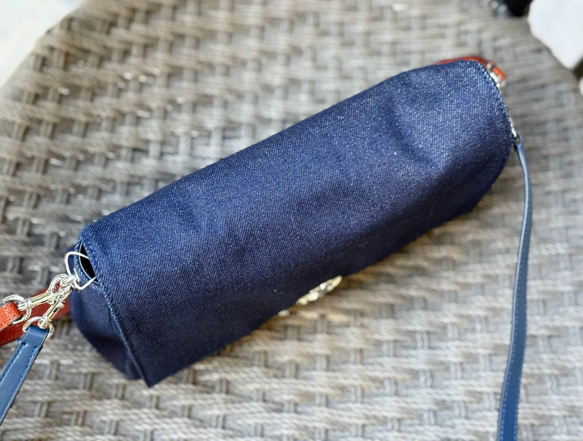 Denim TORY BURCH CHARLE DRNIM SHOULDER BAG denim underarm bag with deep blue denim and contrasting caviar patterned shoulder straps, simple yet textured. The front double T metal logo is highly recognizable, and the underarm back or single shoulder crossb