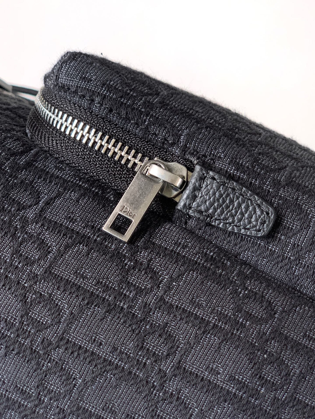 The Heritage Saddle Flap Backpack features a sleek, original design that accentuates your saddle style. Crafted from black Oblique printed fabric, accented with tonal grained calf leather details for added style. A spacious compartment under the saddle