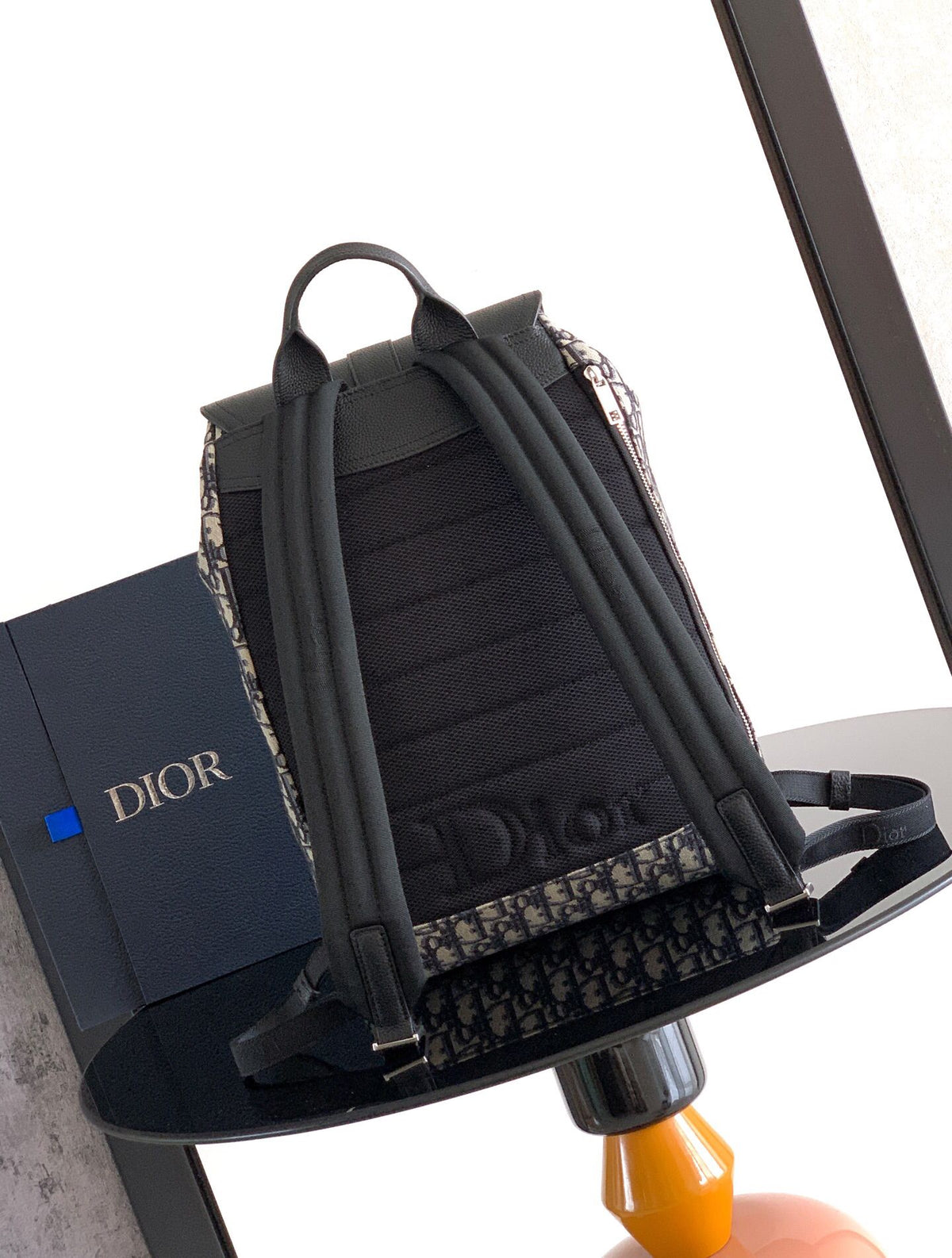 The Heritage Saddle Flap Backpack features a stylish original design that accentuates your saddle style. Crafted from beige and black Oblique print fabric with black grained calf leather details. A spacious compartment under the saddle flap embellished