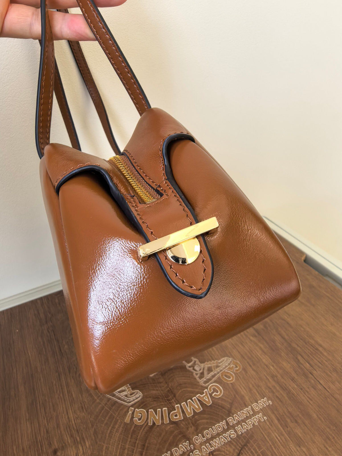 The new TORY BURCH ROBINSON SATCHEL bowling bag is made of oil wax cowhide material, which has a delicate, durable, simple and atmospheric feel. The front brand metal logo is highly recognizable and durable. The bag has a round shape and a large capacity