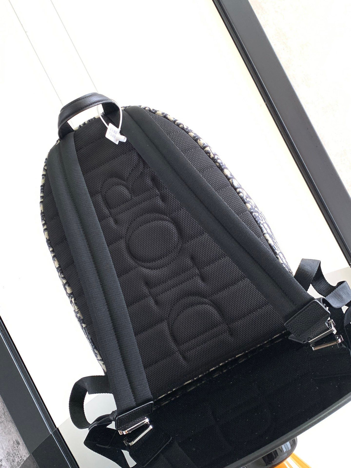 Large black text label. Top original order. This Rider backpack has a simple silhouette. The classic collegiate style is full of vitality. It is fashionable and modern. It is carefully made of beige and black jacquard fabrics and decorated with Oblique