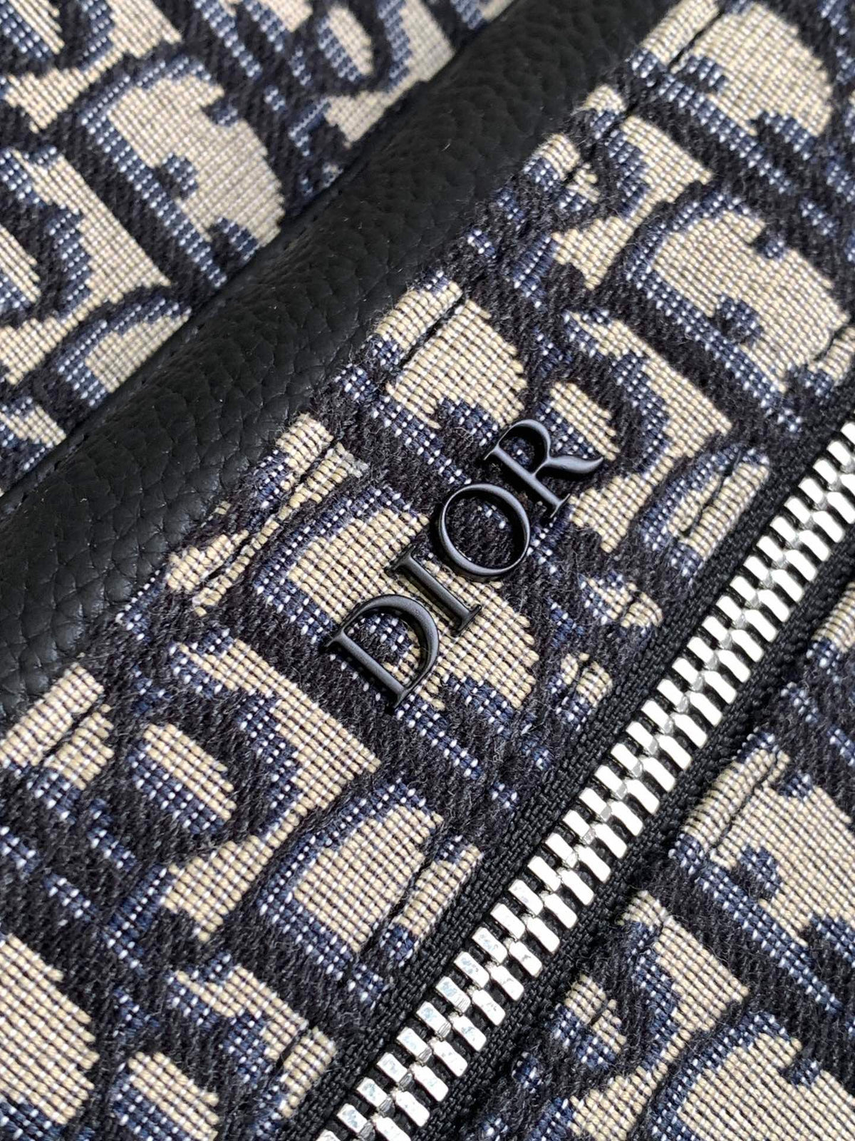 Large black text label. Top original order. This Rider backpack has a simple silhouette. The classic collegiate style is full of vitality. It is fashionable and modern. It is carefully made of beige and black jacquard fabrics and decorated with Oblique
