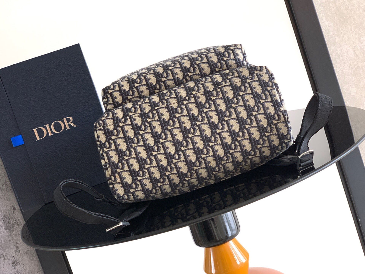 The Heritage Saddle Flap Backpack features a stylish original design that accentuates your saddle style. Crafted from beige and black Oblique print fabric with black grained calf leather details. A spacious compartment under the saddle flap embellished