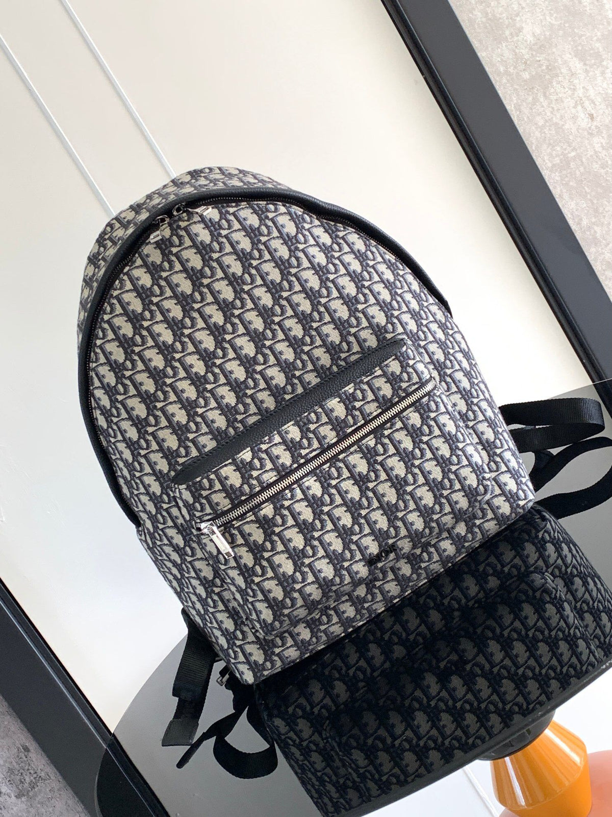 Large black text under the label Top quality original order This Rider backpack has a simple silhouette. The classic college style is full of vitality. Fashionable and modern. Carefully crafted from beige and black jacquard fabrics. Decorated with Oblique