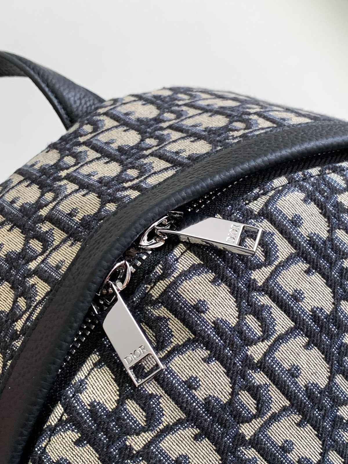 Large black text label. Top original order. This Rider backpack has a simple silhouette. The classic collegiate style is full of vitality. It is fashionable and modern. It is carefully made of beige and black jacquard fabrics and decorated with Oblique
