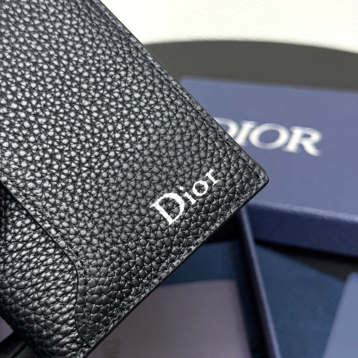 This vertical bifold card holder is elegant and practical. It is crafted from grained cow leather. It is decorated with the CD logo on the front. It has three card slots on each side and two receipt pockets. It is exquisite and elegant. It can be easily