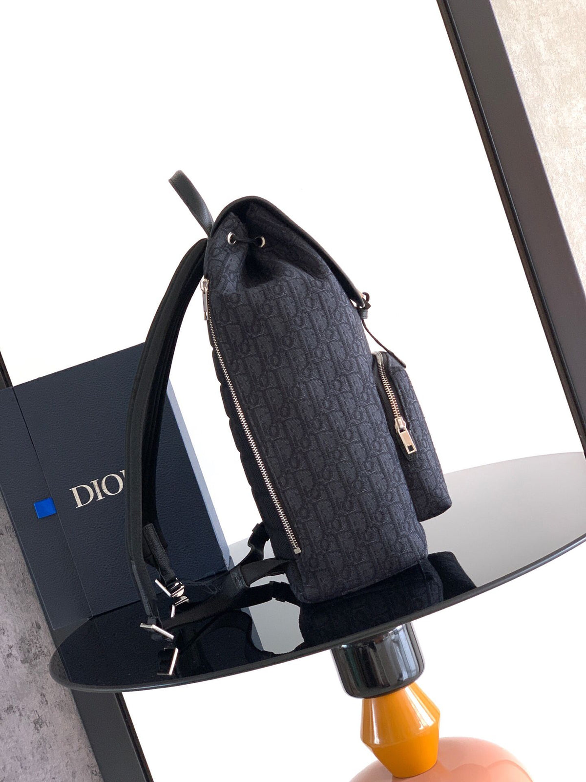 The Heritage Saddle Flap Backpack features a sleek, original design that accentuates your saddle style. Crafted from black Oblique printed fabric, accented with tonal grained calf leather details for added style. A spacious compartment under the saddle