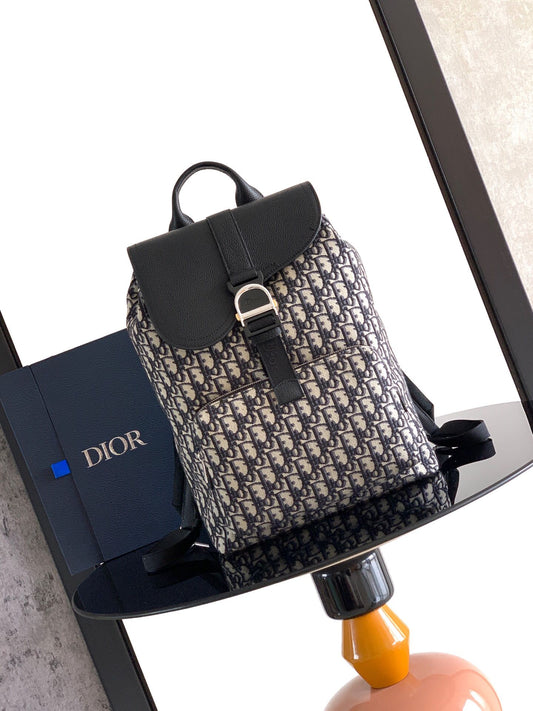 The Heritage Saddle Flap Backpack features a stylish original design that accentuates your saddle style. Crafted from beige and black Oblique print fabric with black grained calf leather details. A spacious compartment under the saddle flap embellished