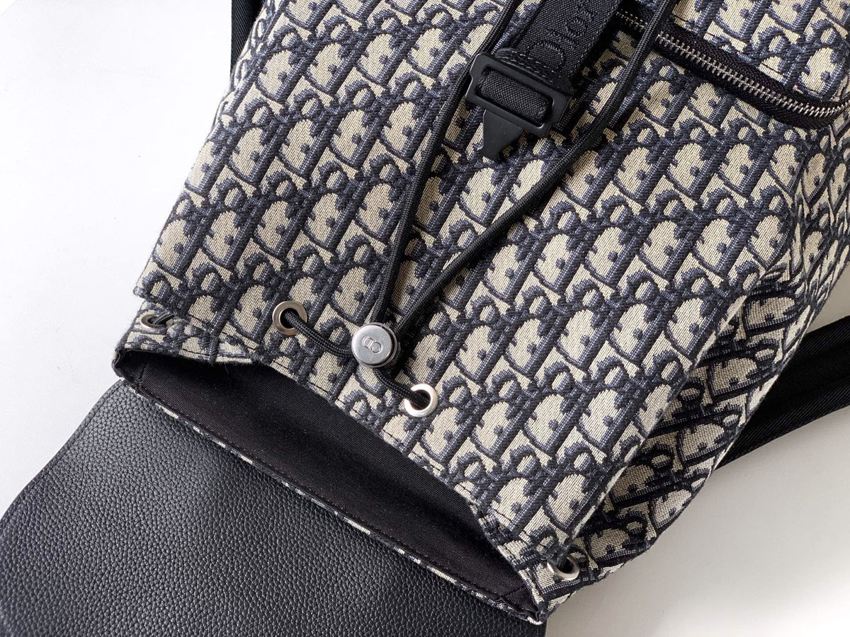 The Heritage Saddle Flap Backpack features a stylish original design that accentuates your saddle style. Crafted from beige and black Oblique print fabric with black grained calf leather details. A spacious compartment under the saddle flap embellished