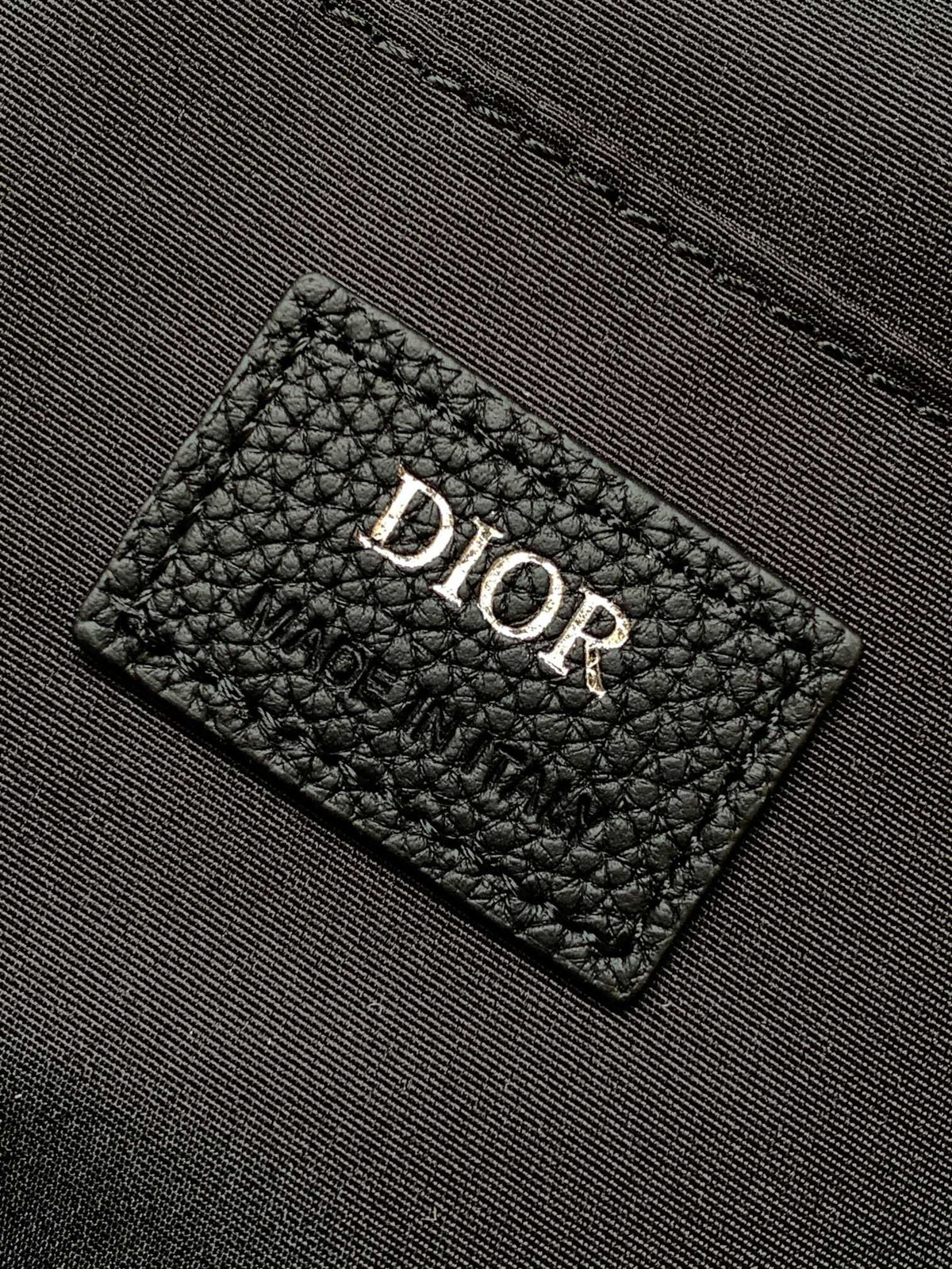Large black text under the label Top quality original order This Rider backpack has a simple silhouette. The classic college style is full of vitality. Fashionable and modern. Carefully crafted from beige and black jacquard fabrics. Decorated with Oblique
