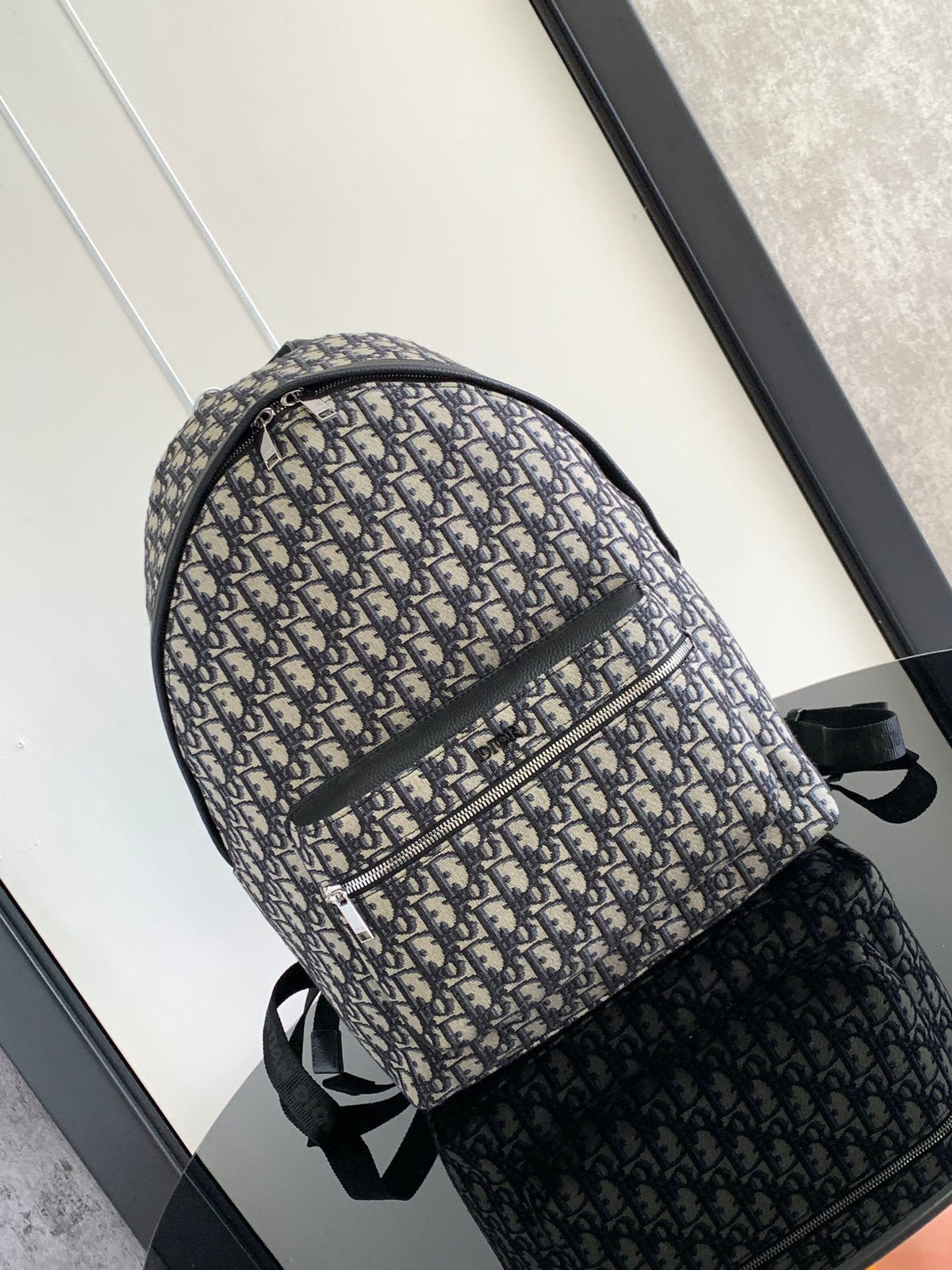 Large black text label. Top original order. This Rider backpack has a simple silhouette. The classic collegiate style is full of vitality. It is fashionable and modern. It is carefully made of beige and black jacquard fabrics and decorated with Oblique