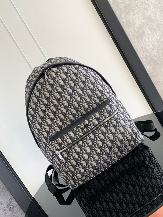 Large black text label. Top original order. This Rider backpack has a simple silhouette. The classic collegiate style is full of vitality. It is fashionable and modern. It is carefully made of beige and black jacquard fabrics and decorated with Oblique