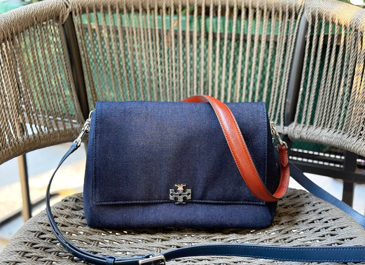 Denim TORY BURCH CHARLE DRNIM SHOULDER BAG denim underarm bag with deep blue denim and contrasting caviar patterned shoulder straps, simple yet textured. The front double T metal logo is highly recognizable, and the underarm back or single shoulder crossb
