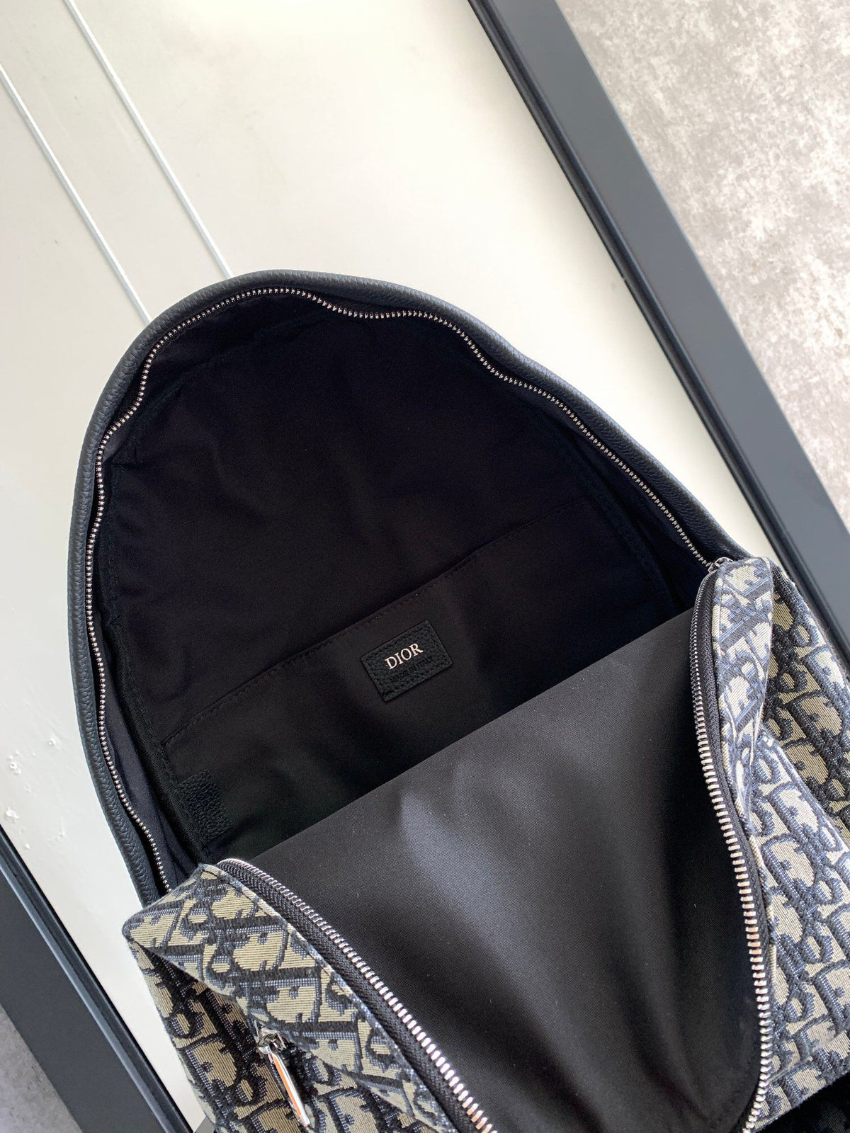 Large black text under the label Top quality original order This Rider backpack has a simple silhouette. The classic college style is full of vitality. Fashionable and modern. Carefully crafted from beige and black jacquard fabrics. Decorated with Oblique