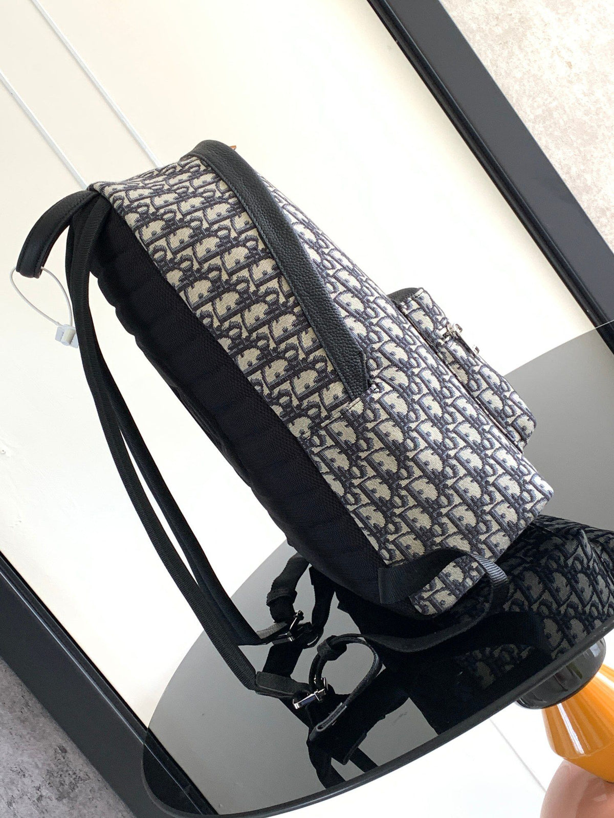 Large black text under the label Top quality original order This Rider backpack has a simple silhouette. The classic college style is full of vitality. Fashionable and modern. Carefully crafted from beige and black jacquard fabrics. Decorated with Oblique