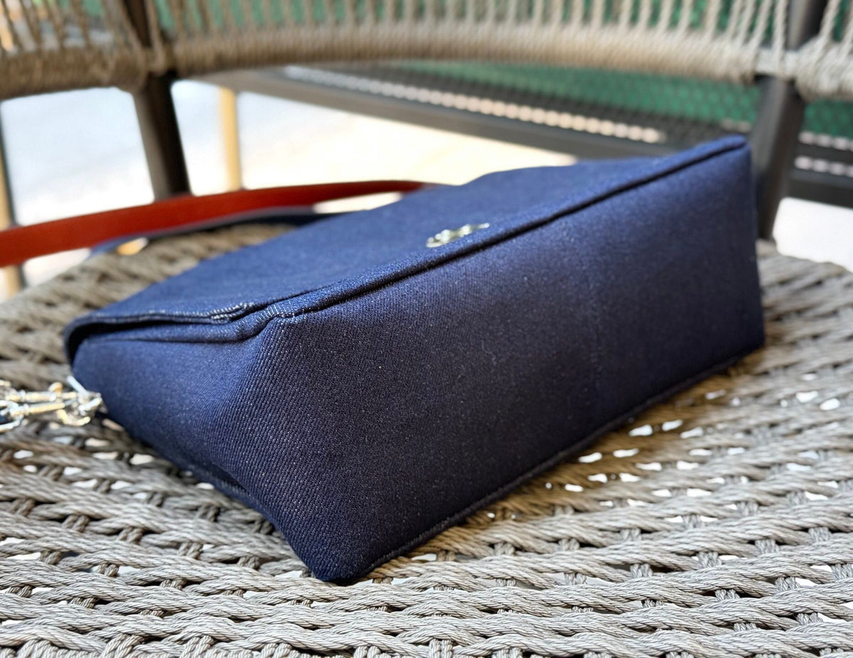 Denim TORY BURCH CHARLE DRNIM SHOULDER BAG denim underarm bag with deep blue denim and contrasting caviar patterned shoulder straps, simple yet textured. The front double T metal logo is highly recognizable, and the underarm back or single shoulder crossb