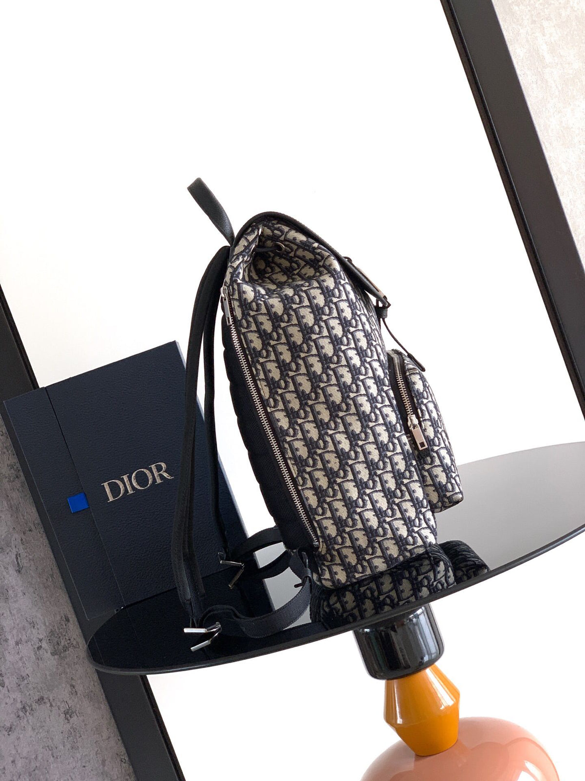 The Heritage Saddle Flap Backpack features a stylish original design that accentuates your saddle style. Crafted from beige and black Oblique print fabric with black grained calf leather details. A spacious compartment under the saddle flap embellished