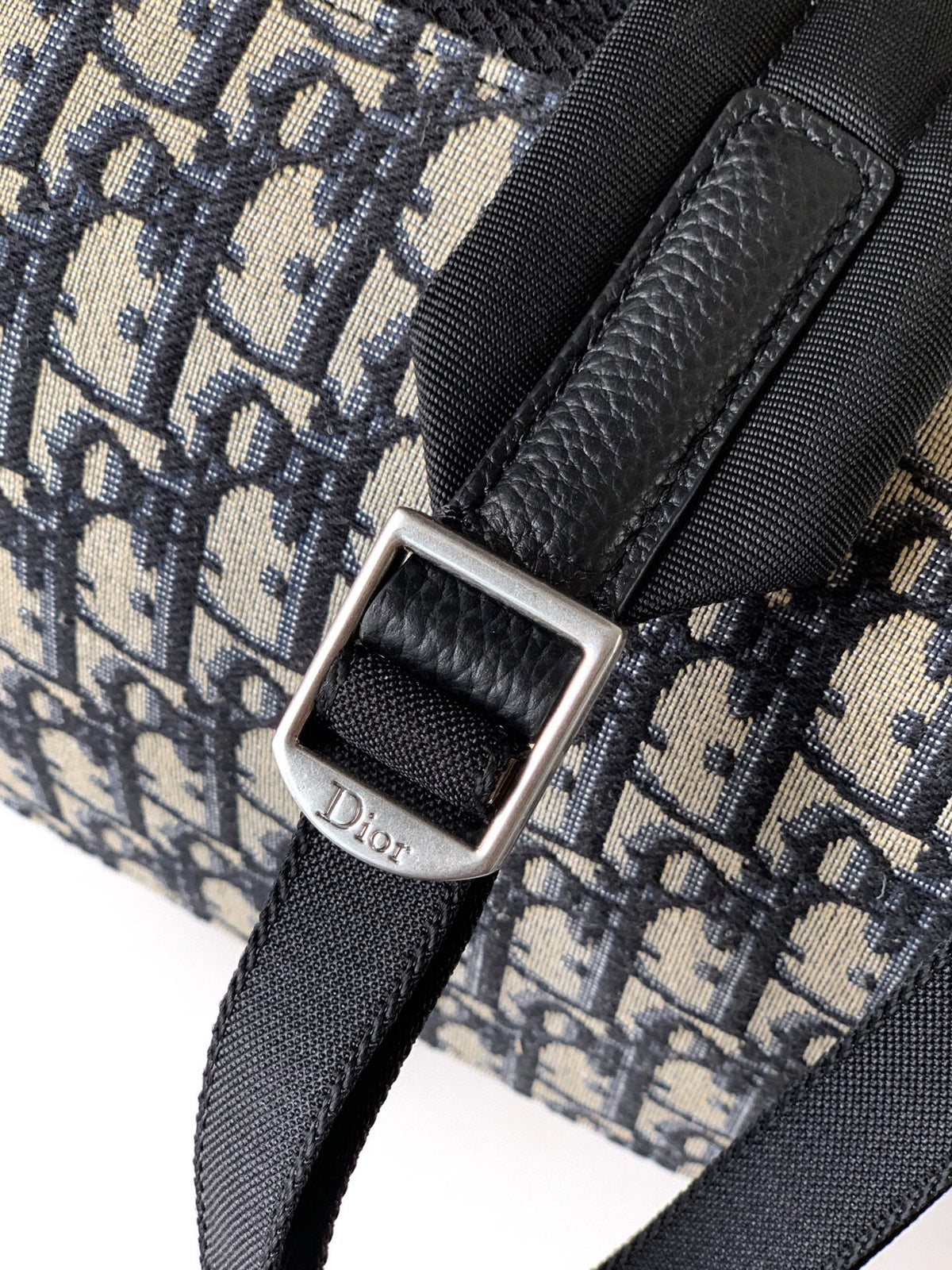 The Heritage Saddle Flap Backpack features a stylish original design that accentuates your saddle style. Crafted from beige and black Oblique print fabric with black grained calf leather details. A spacious compartment under the saddle flap embellished