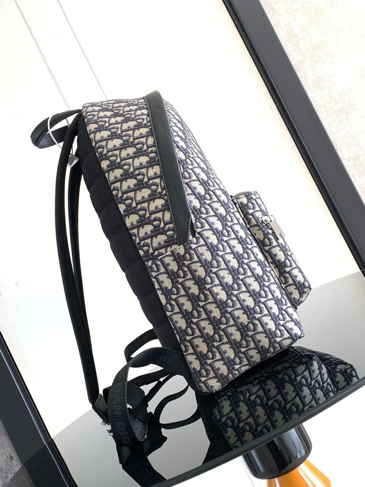 Large black text label. Top original order. This Rider backpack has a simple silhouette. The classic collegiate style is full of vitality. It is fashionable and modern. It is carefully made of beige and black jacquard fabrics and decorated with Oblique