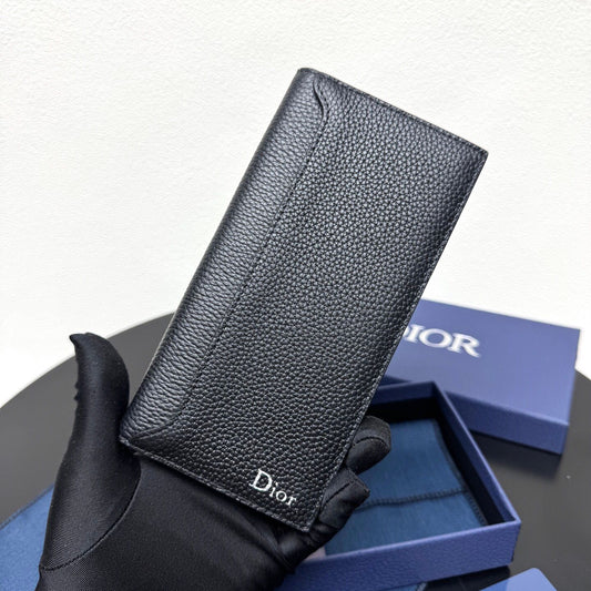 Stylish and functional, this vertical bi-fold wallet is crafted from black grained cow leather. Vertical bi-fold design. CD logo on front for added style. Features five cash compartments, 16 card slots and a zippered coin compartment. Long vertical design