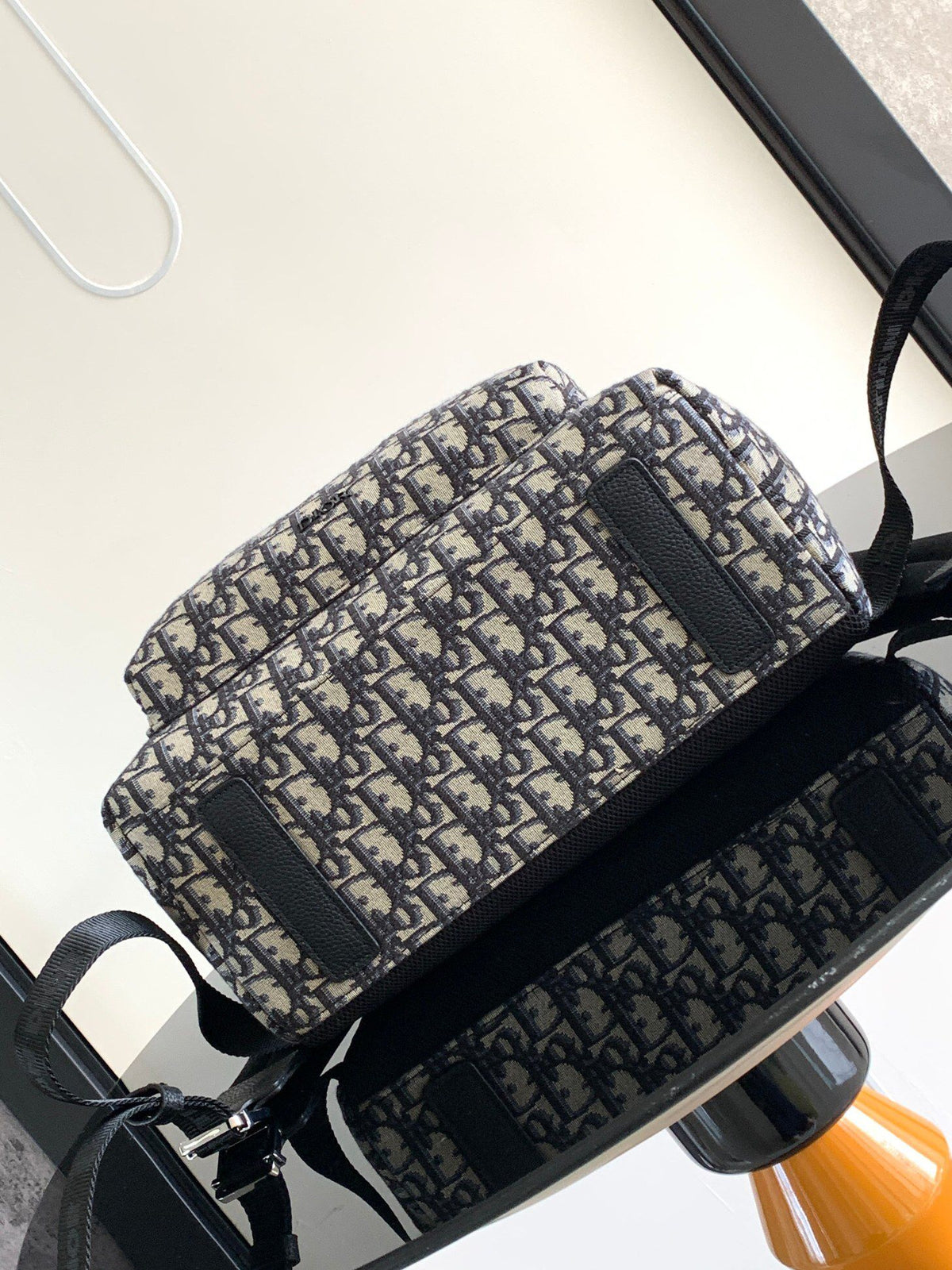 Large black text under the label Top quality original order This Rider backpack has a simple silhouette. The classic college style is full of vitality. Fashionable and modern. Carefully crafted from beige and black jacquard fabrics. Decorated with Oblique